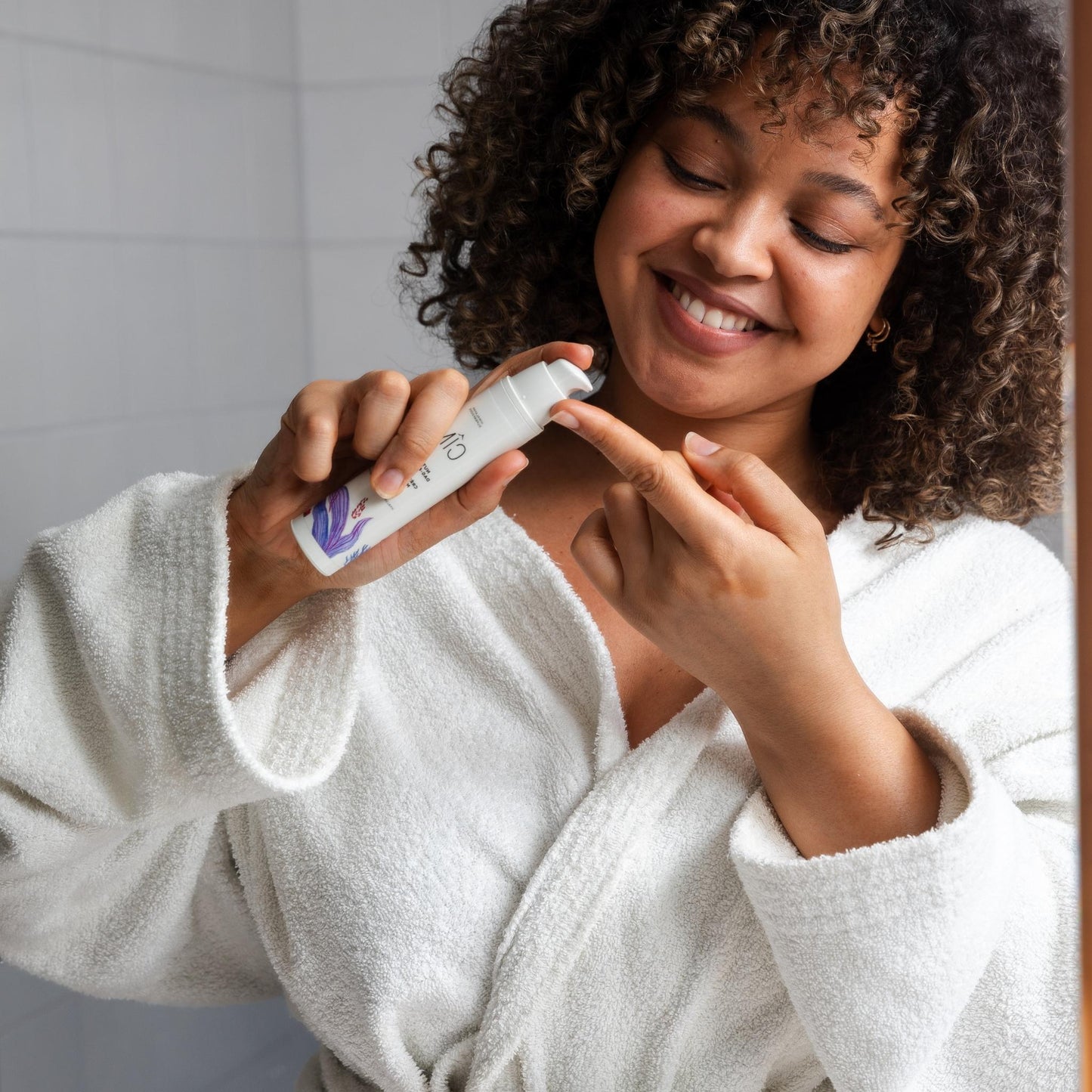 vrouw doet natuurlijke dag- en nachtcreme op haar vinger