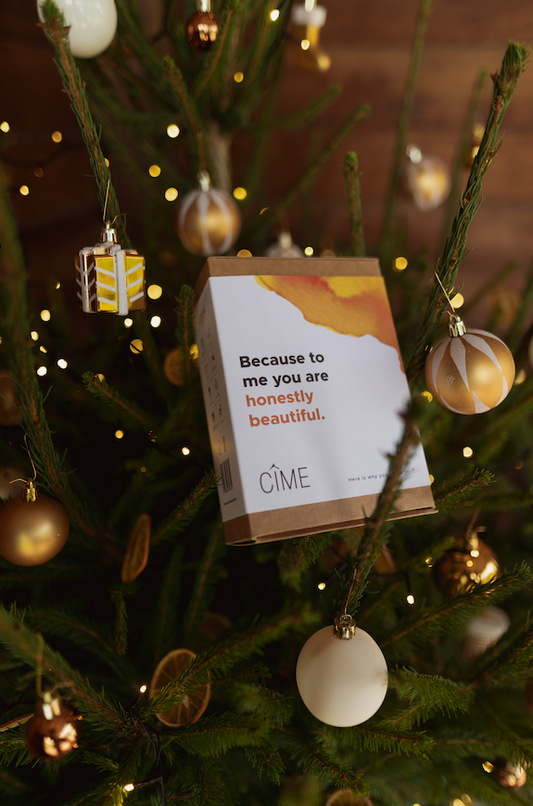 CÎME magic care set wrapped as gift in Christmas tree with decorations