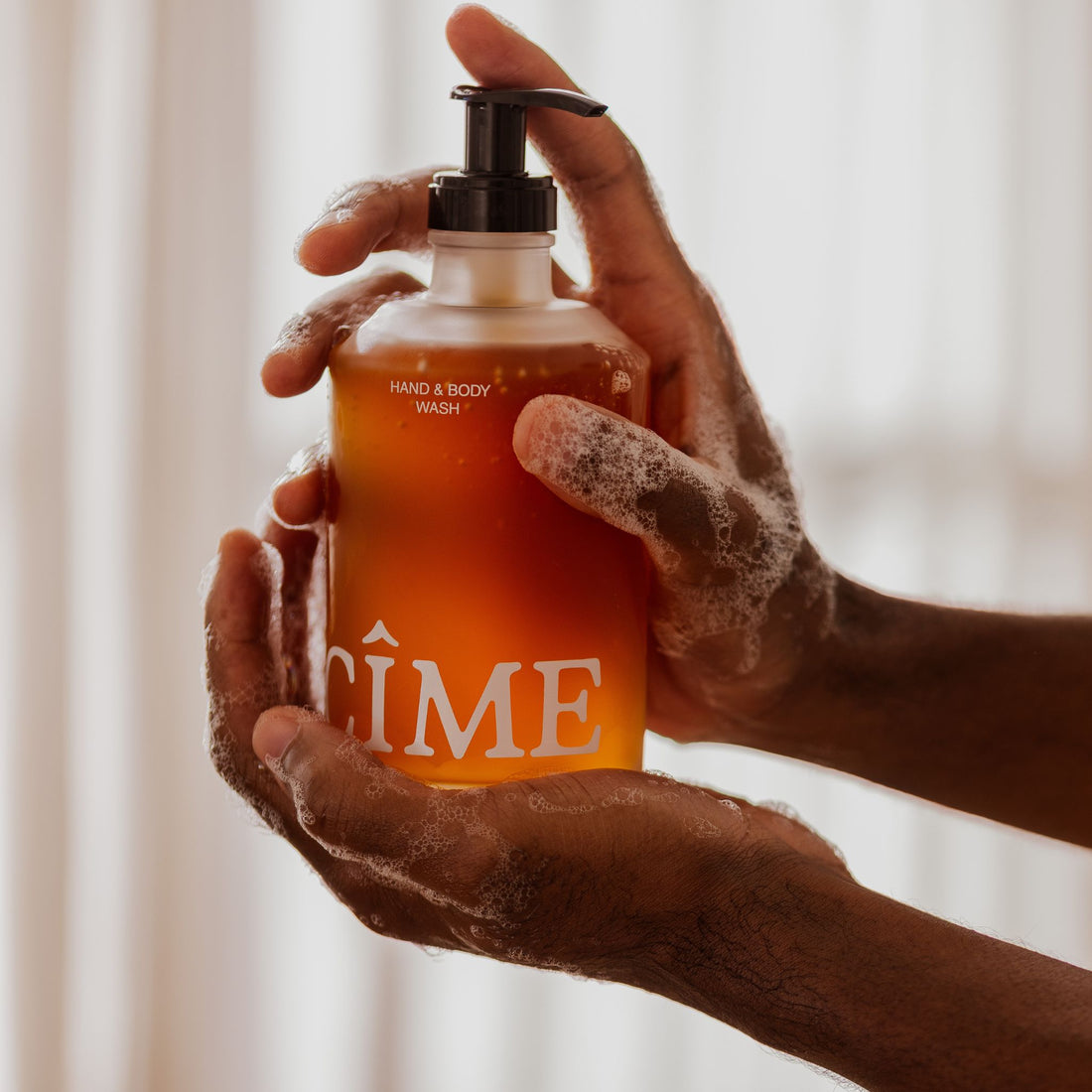 Hand and body wash glass bottle and foamy hands