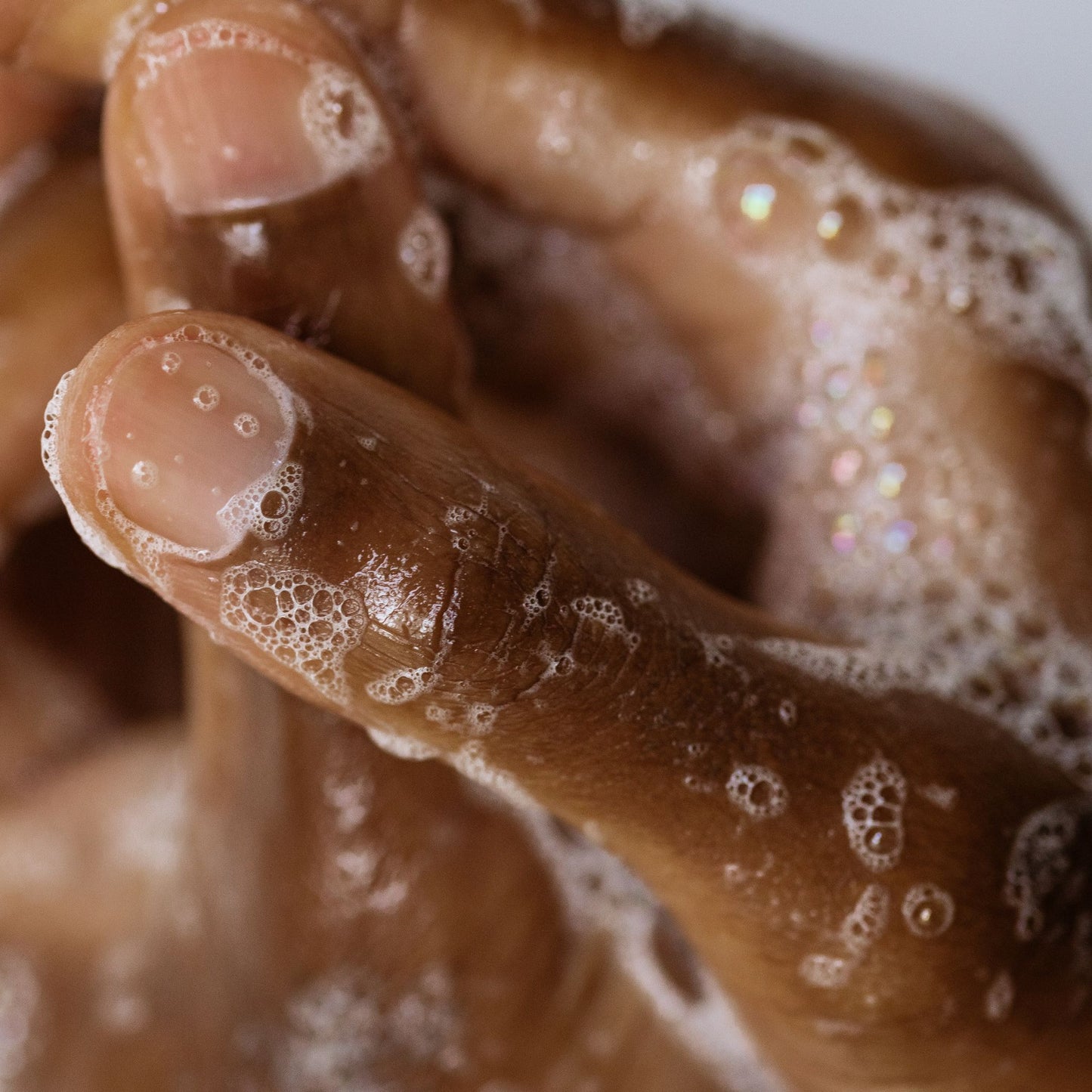Hands feeling the soft and foamy soap